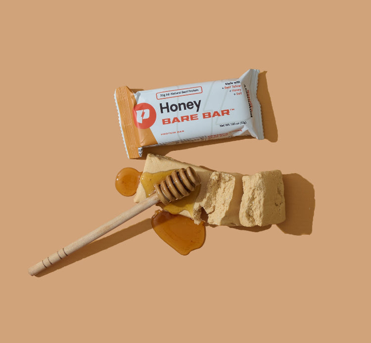 Honey Bare Bar with a honey dipper on a beige background